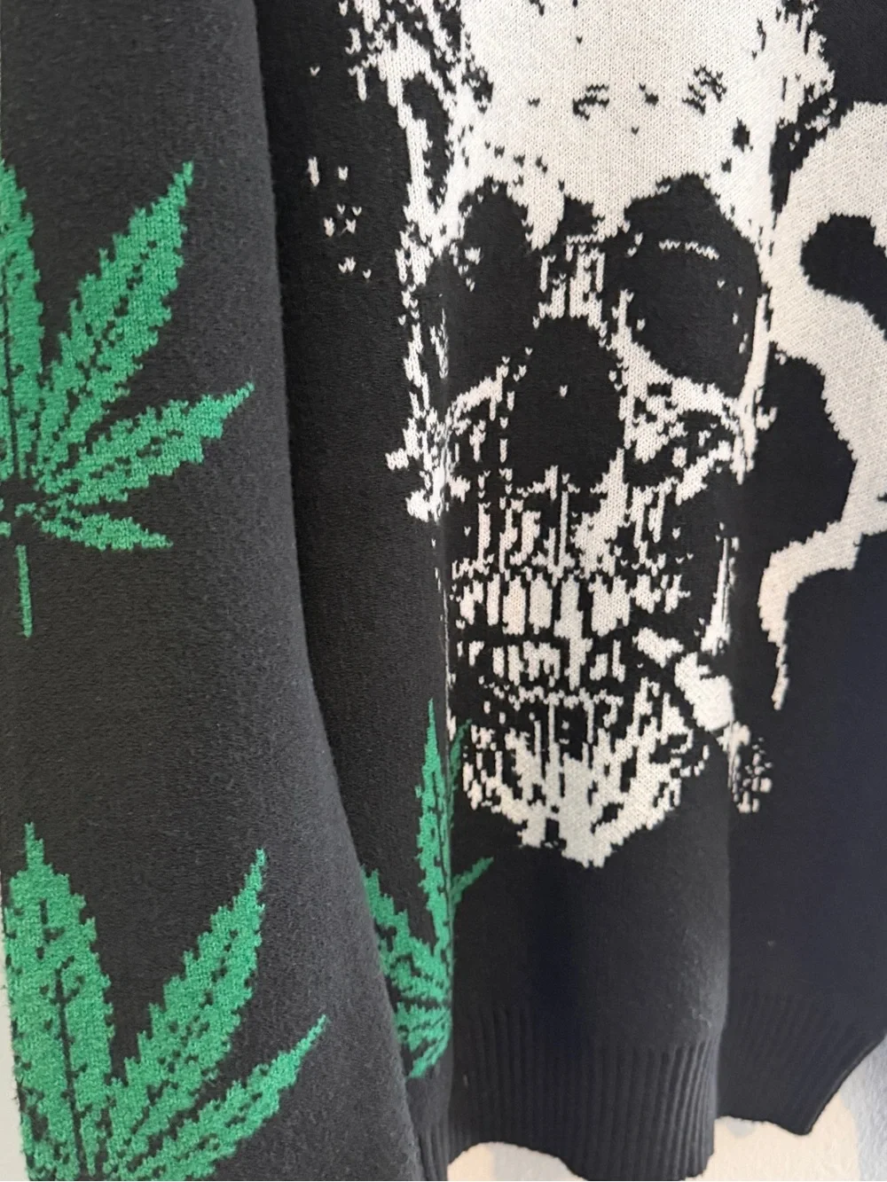 Men's Black Skull Graphic Knit Sweater with Green Leaf Accents
